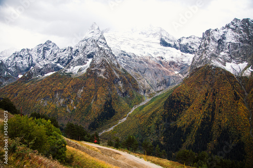 Breathtaking view on Dombay mountains valley and rocky peaks of the glaciers, Russia, Caucasus autumn landscape.