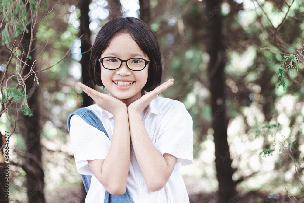 Cute little girl with glasses smiling in the park on a sunny day Cute little girl with glasses smiling in the park on a sunny day