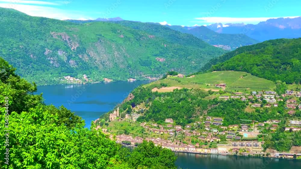 Panoramic View over Alpine Lake Lugano and Village Morcote and Mountain in a Sunny Day in Ticino, Switzerland. Panoramic View over Alpine Lake Lugano and Village Morcote and Mountain in a Sunny Day in Ticino, Switzerland.