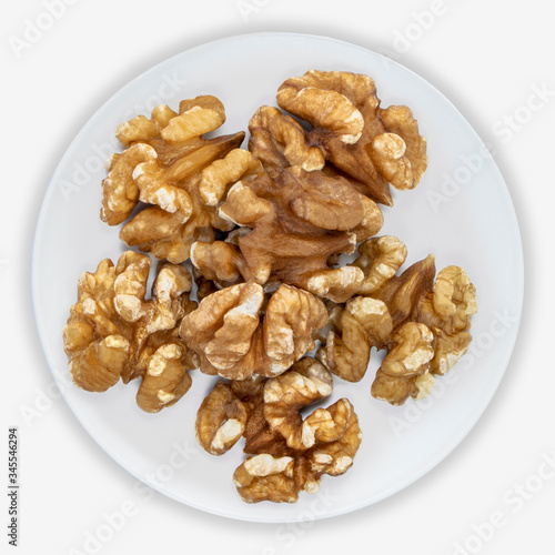 Walnuts to on a white plate. Isolated background. View from above.
