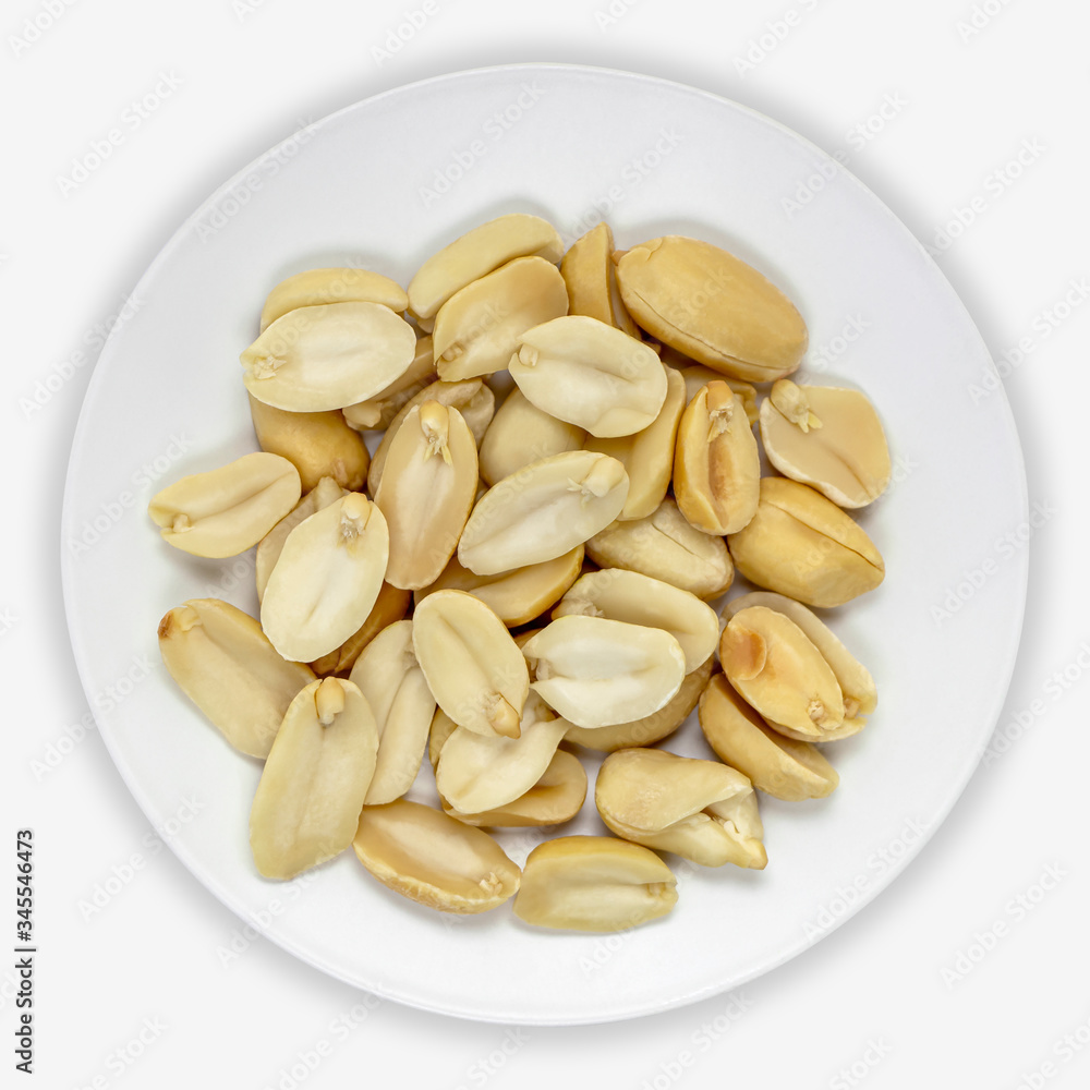 Peanuts on a white plate. Isolated background. View from above. Peanuts on a white plate. Isolated background. View from above.