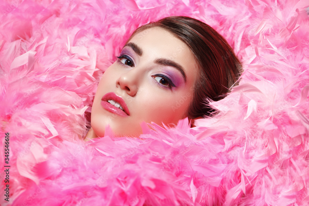face surrounded by fluffy pink boa face surrounded by fluffy pink boa