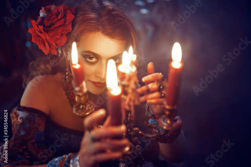 bewitching woman with candles © Andrey Kiselev