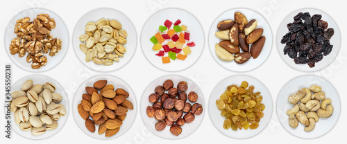 Panorama of calves with various nuts and dried fruits. Hazelnuts  peanuts  cashews  Brazil nut  almonds  pistachios. Isolated background. View from above.