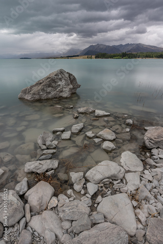 Lake Tekapo, New Zealand - January 8, 2020 : Long exposure of Lake Tekapo on a cloudy late afternoon