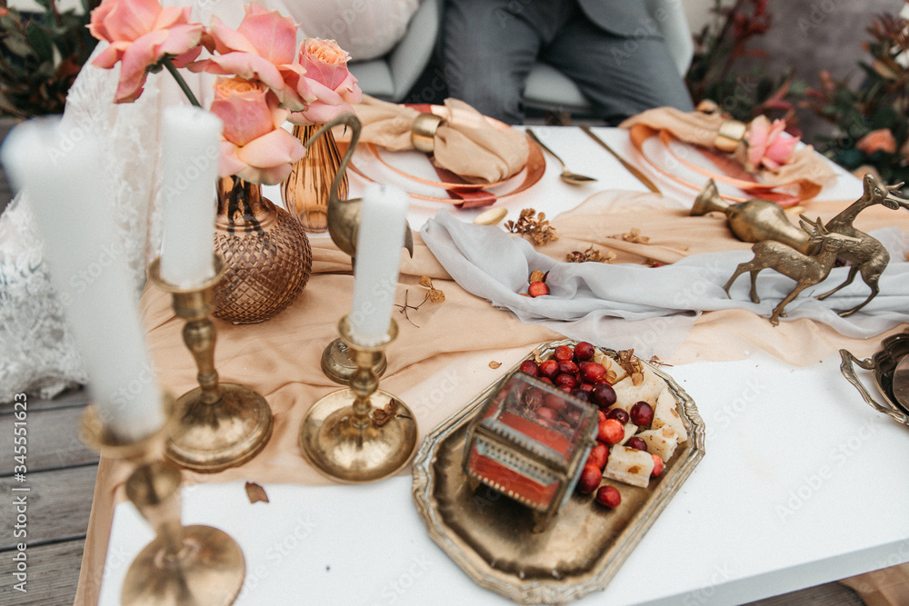 Delicate wedding decorated with pomegranate and succulent surrounded by flowers and candles Delicate wedding decorated with pomegranate and succulent surrounded by flowers and candles