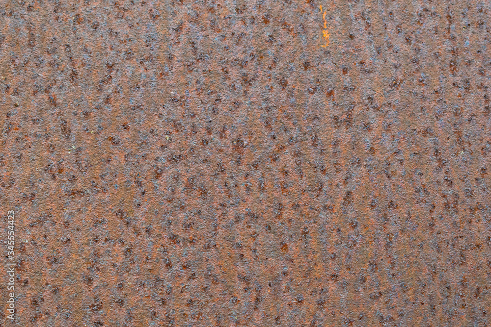 Rusty metal plate background with little orange spot Rusty metal plate background with little orange spot