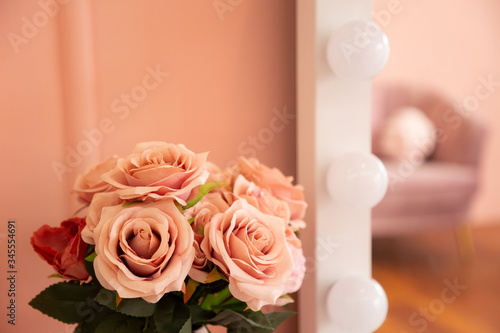 pink rose decoration on makeup table in sweet minimal pastel room .