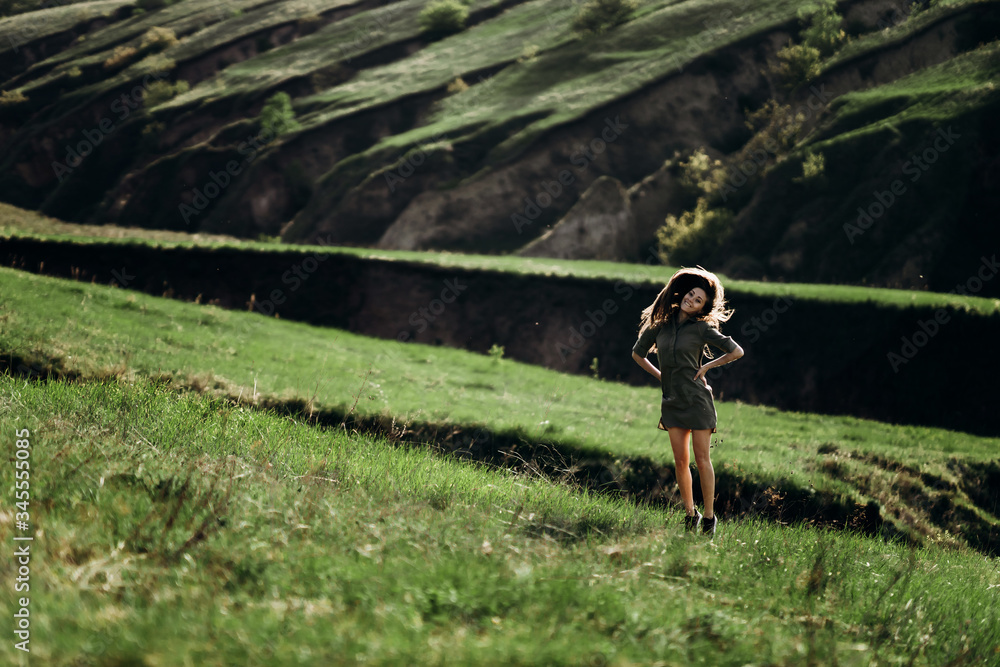 Fototapeta premium beautiful emotional girl on green saturated hills