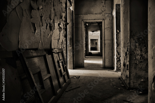 The door lies on the floor in an abandoned house