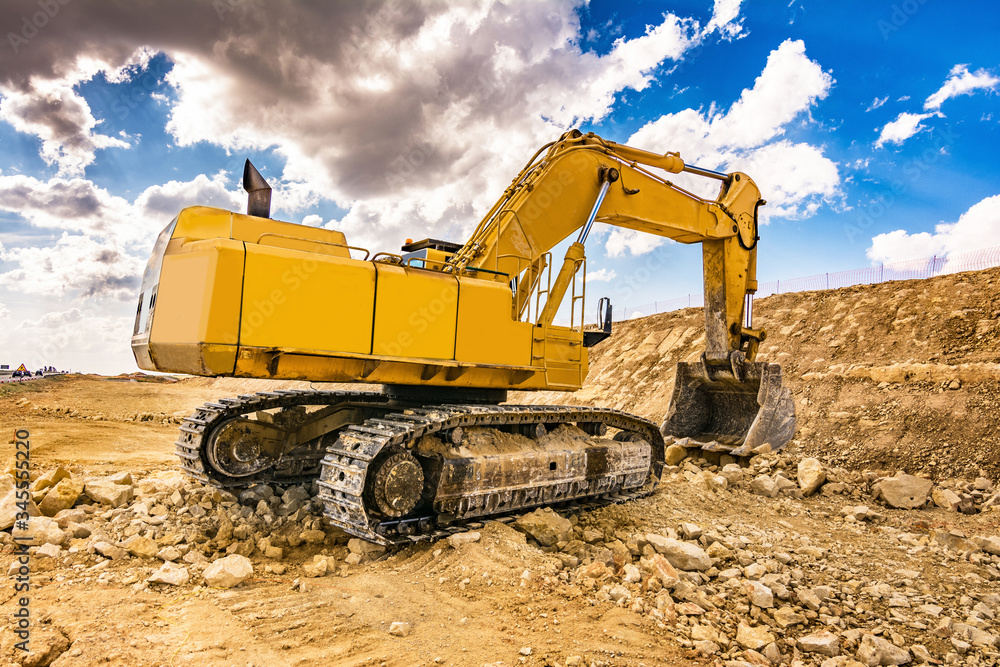 Excavator in a quarry extracting stone Excavator in a quarry extracting stone