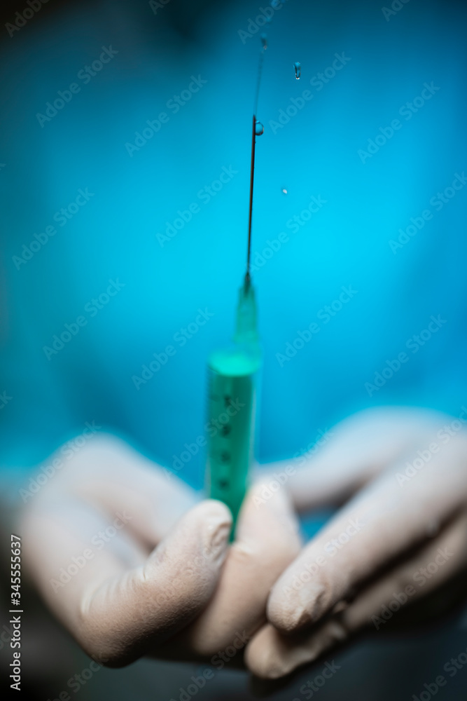 Nurse holding a Syringe and a vaccine container. Nurse holding a Syringe and a vaccine container.
