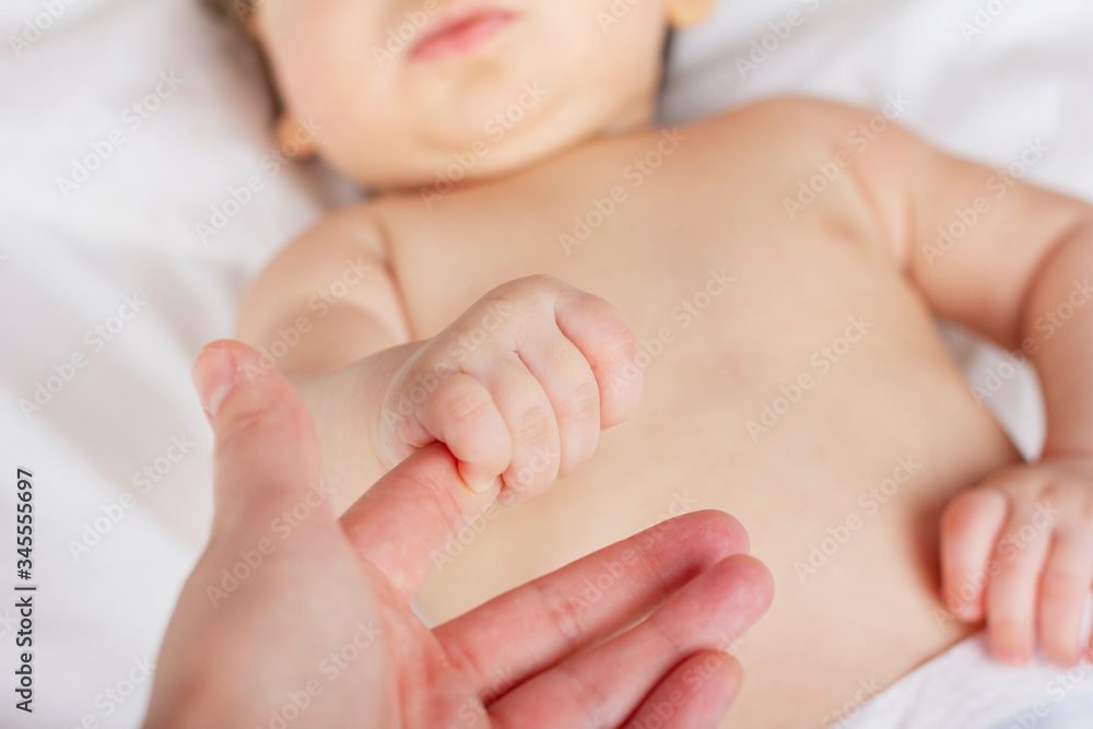 Newborn child. Children's hand holds a female hand. Maternity hospital. Newborn child. Children's hand holds a female hand. Maternity hospital.