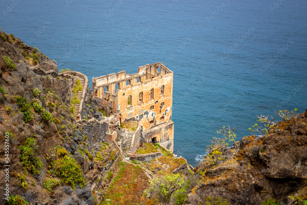 Abandoned building on a cliff by the sea