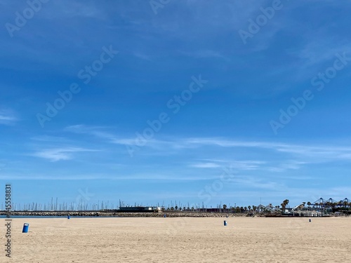 Spain's deserted beaches during siesta and quarantine. Blue sky and bright sun and white sand. Valencia, Spain