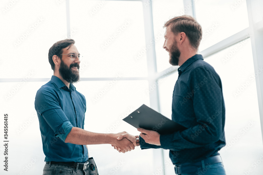 meeting and shaking hands with business people in a bright office meeting and shaking hands with business people in a bright office