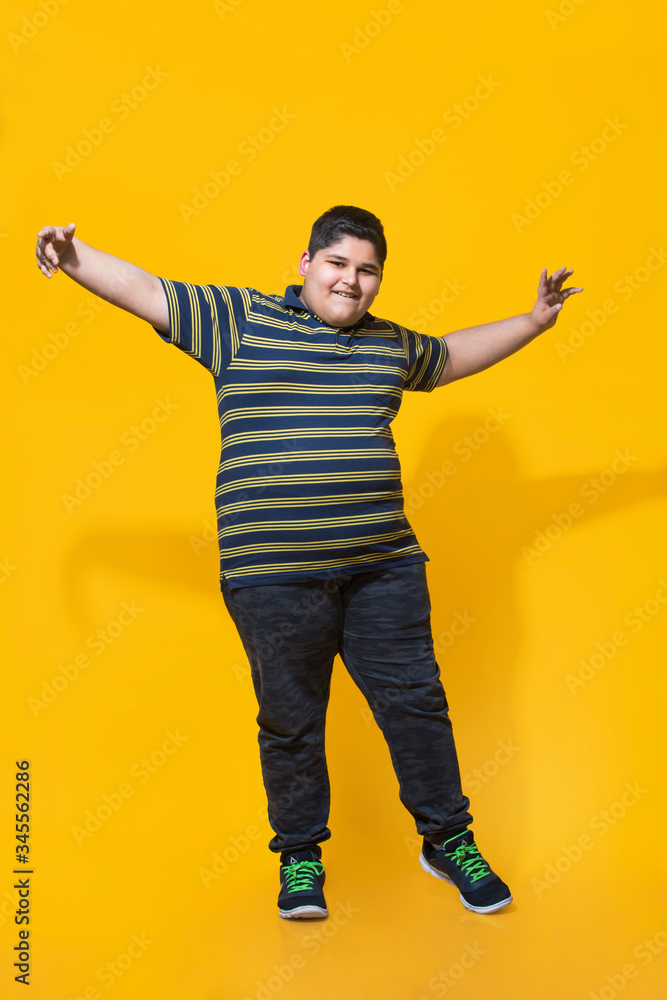 Chubby boy smiling and dancing.(Obesity) Chubby boy smiling and dancing.(Obesity)