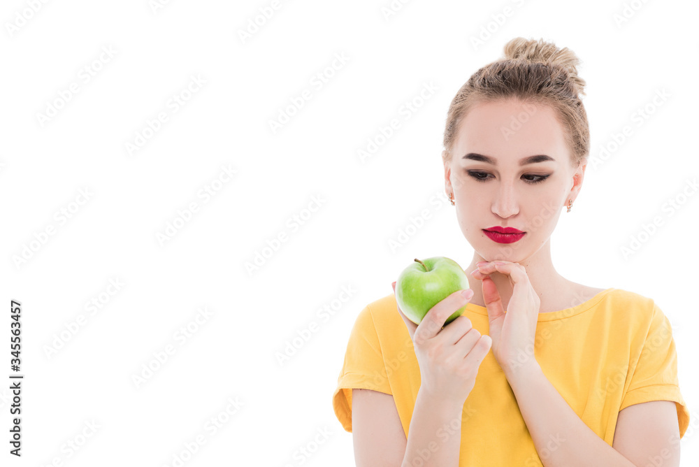 Emotional portrait of a girls who eat an apple on an isolated white background. The concept of a healthy diet, healthy lifestyle and vegetarianism Emotional portrait of a girls who eat an apple on an isolated white background. The concept of a healthy diet, healthy lifestyle and vegetarianism