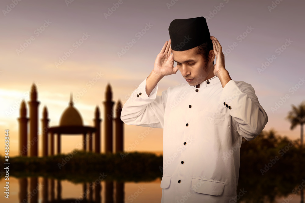Asian Muslim man in praying position (salat)