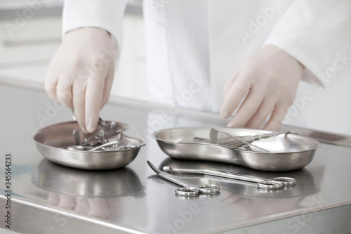 Hands of a nurse taking medical instruments