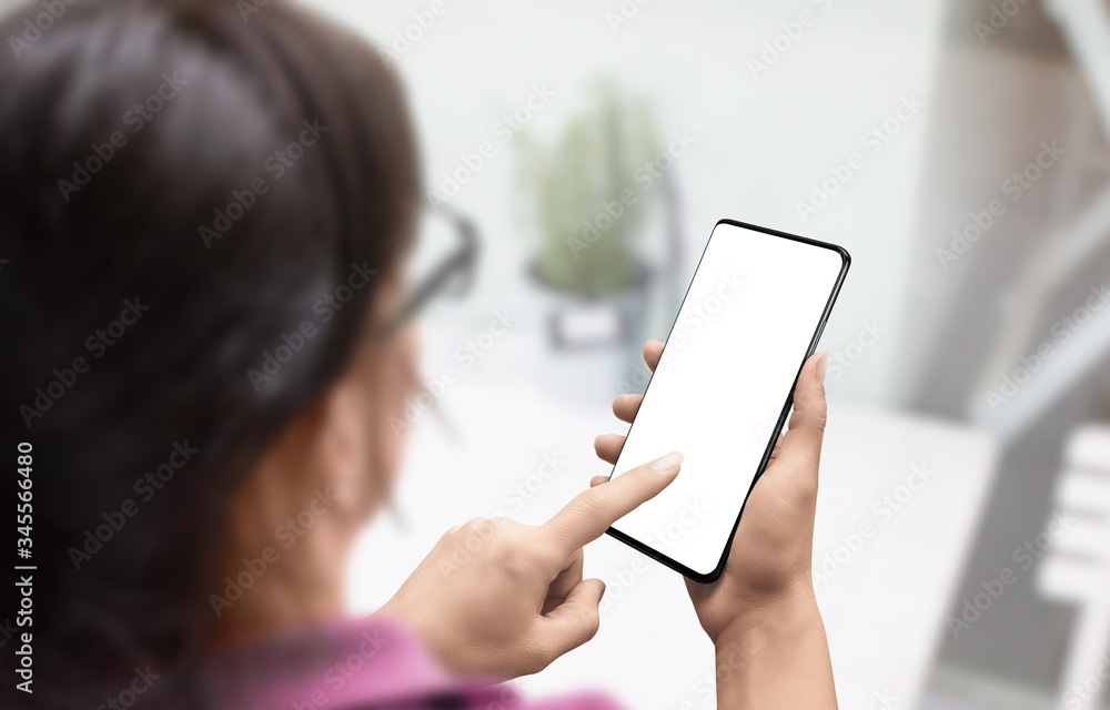 Phone mockup in woman hands. View over shoulder. Girl touch phone screen with left hand