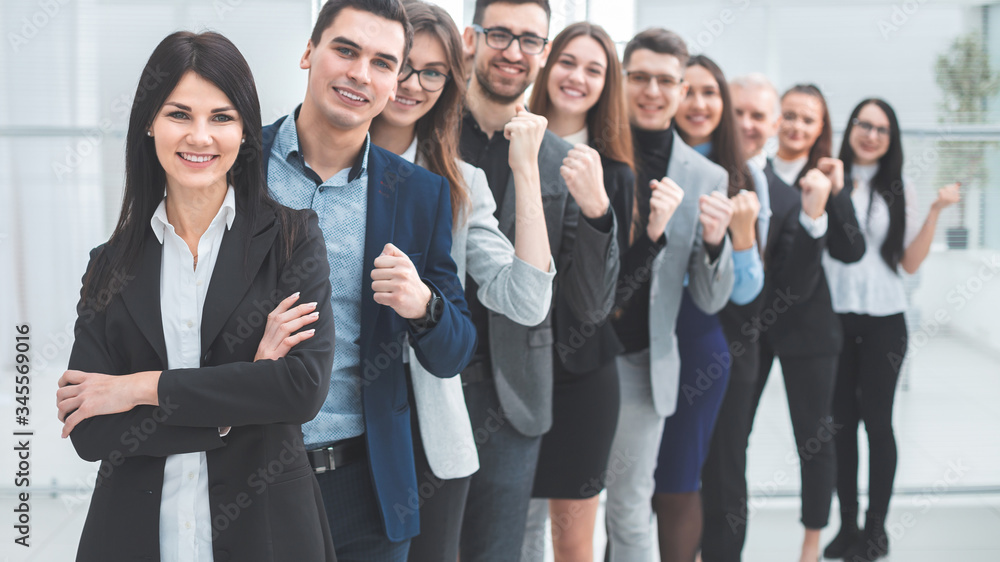 group of happy young people standing in a row