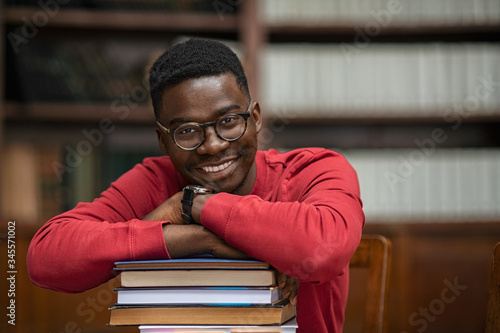Tableau sur toile African student on pile of books
