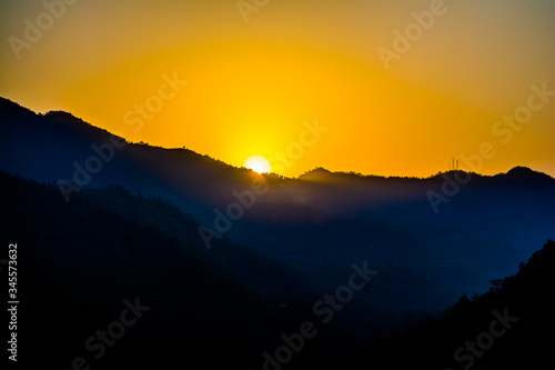 Sunrise behind the mountains of Rishikesh, Located in the foothills of the Himalayas in northern India, 