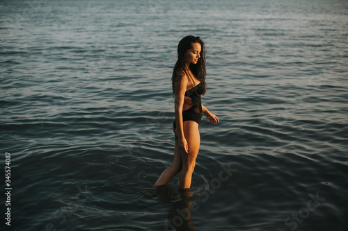 Young woman walking in water at the beach © BGStock72