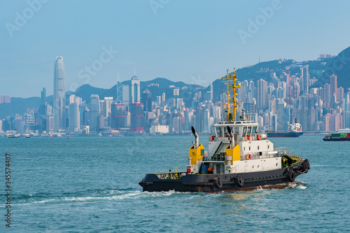 Tug boat in Victoria harbour of Hong Kong city