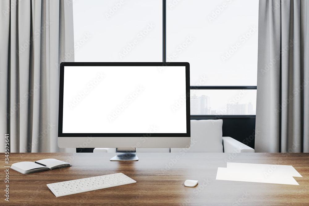 Contemporary office workplace in interior with empty white computer monitor Contemporary office workplace in interior with empty white computer monitor