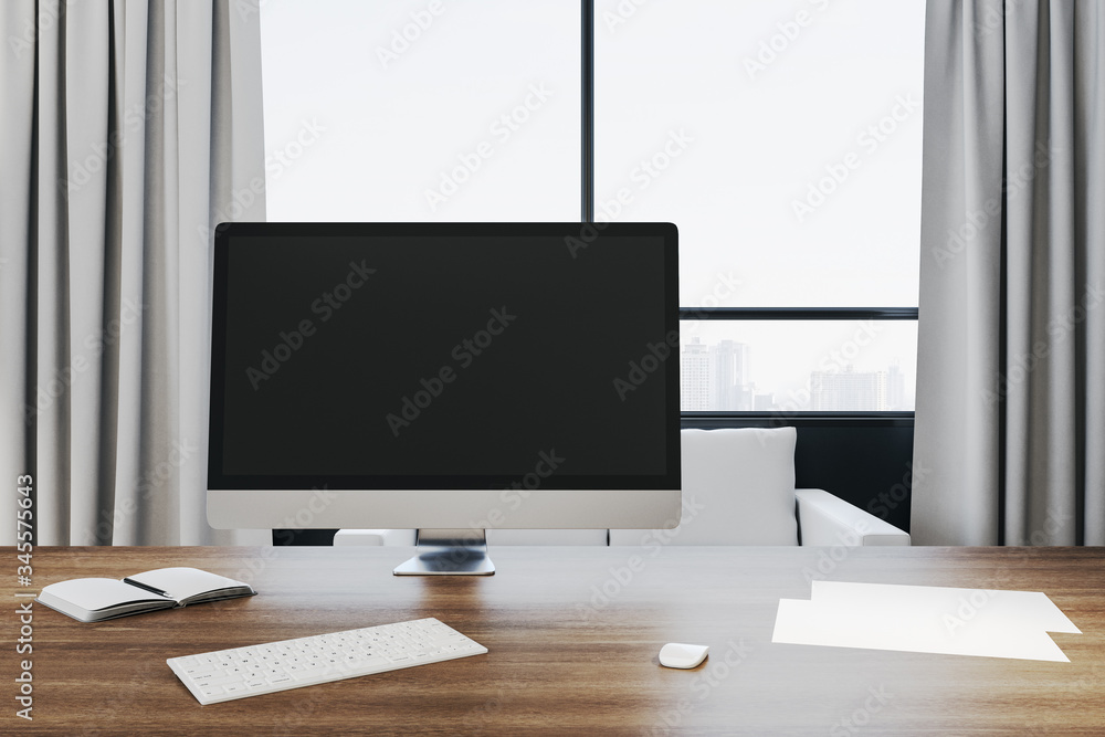 Modern office workplace in interior with empty black computer monitor Modern office workplace in interior with empty black computer monitor