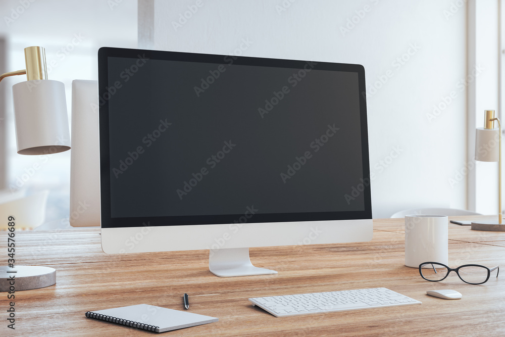 Modern designer desktop with empty computer screen Modern designer desktop with empty computer screen