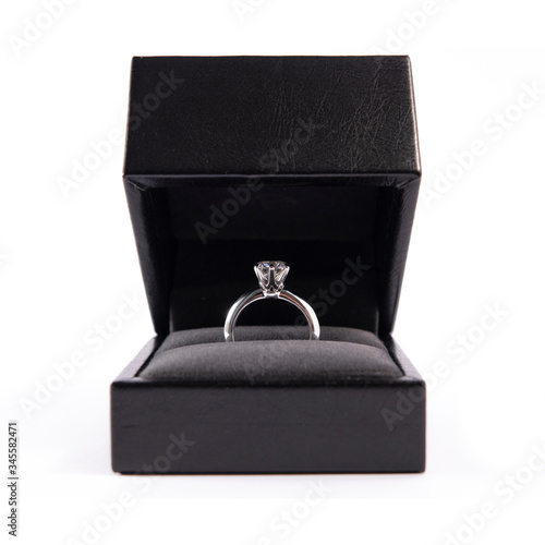 Jewelry, golden diamond ring in a box on a white background, isolated.