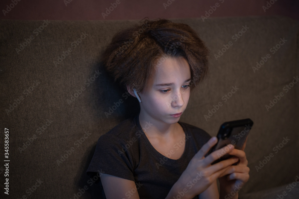 teenager uses mobile phone and wireless headphones, social networking concept, online communication, distance learning teenager uses mobile phone and wireless headphones, social networking concept, online communication, distance learning