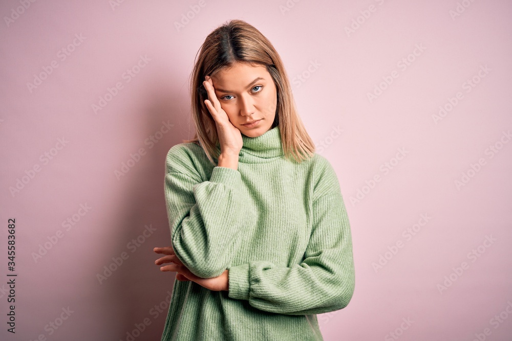 Young beautiful blonde woman wearing winter wool sweater over pink isolated background thinking looking tired and bored with depression problems with crossed arms. Young beautiful blonde woman wearing winter wool sweater over pink isolated background thinking looking tired and bored with depression problems with crossed arms.