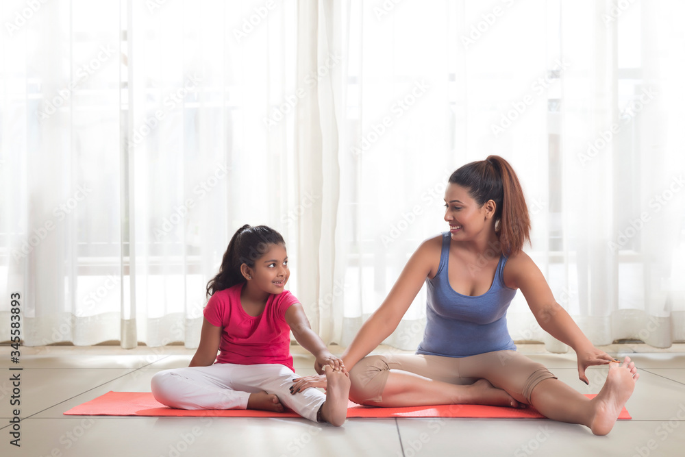 Mother teaching exercise to her daughter
Mother teaching exercise to her daughter