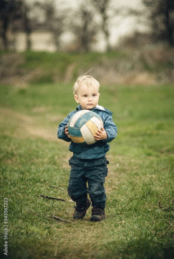 little boy plays ball outdoors little boy plays ball outdoors