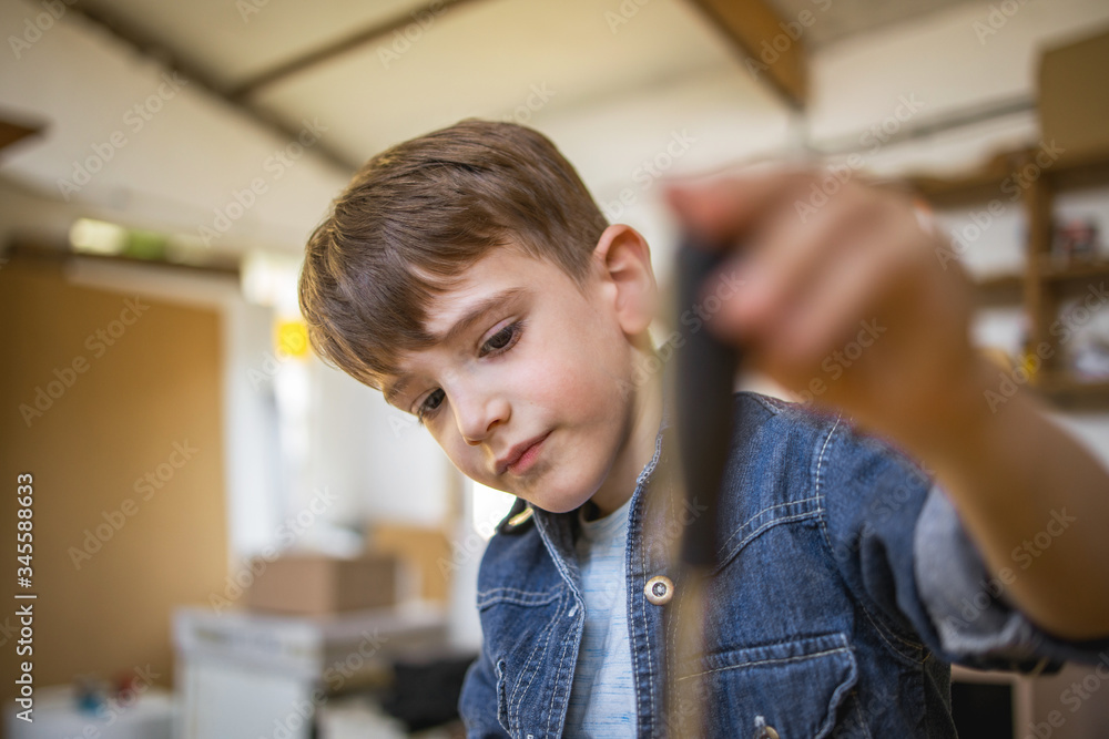 Cute Boy using a screwdriver Cute Boy using a screwdriver