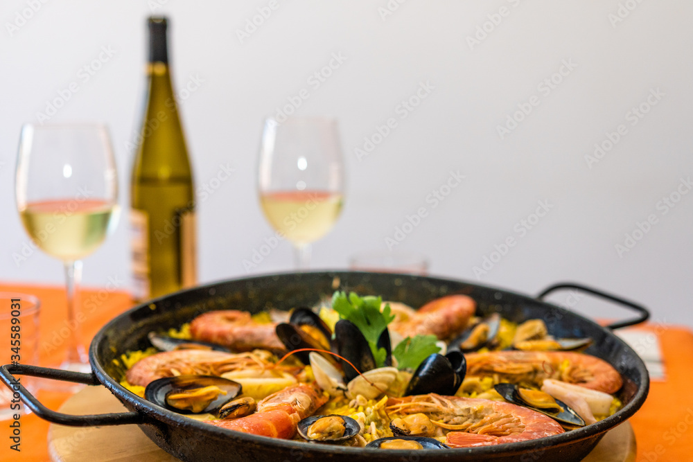 Seafood paella on an orange background