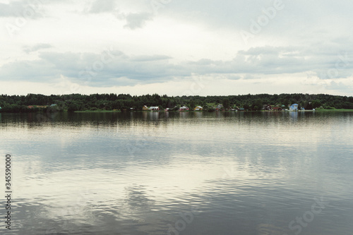 smooth lake and banks with grass © kapralov