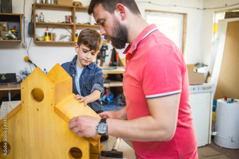 Father and Son Making a Birdhouse Father and Son Making a Birdhouse