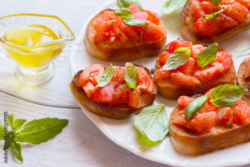 Bruschetta with tomatoes and Basil on a plate top view