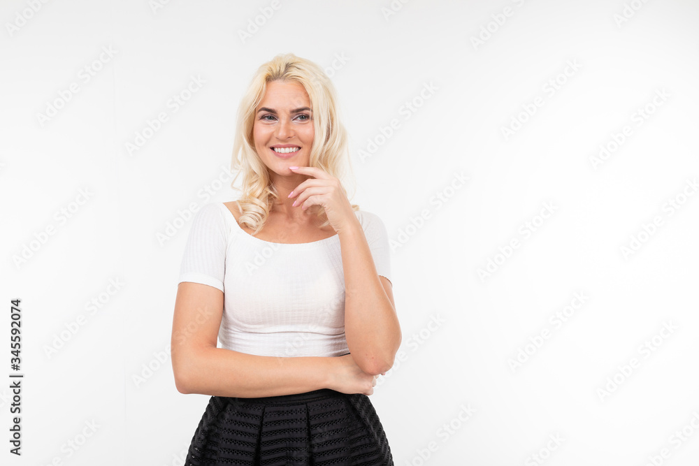 charming flirtatious girl in a white t-shirt with a layout smiles on a white background isolated studio charming flirtatious girl in a white t-shirt with a layout smiles on a white background isolated studio
