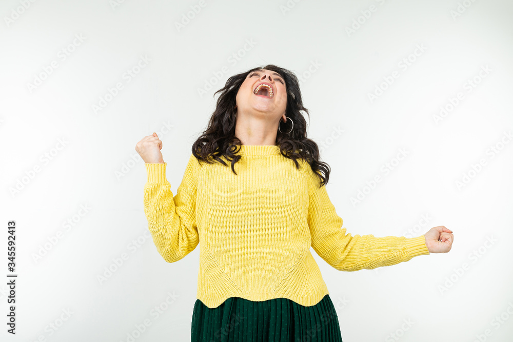 charming stylish girl in a yellow blouse and a green skirt dancing energetically on an isolated white background charming stylish girl in a yellow blouse and a green skirt dancing energetically on an isolated white background
