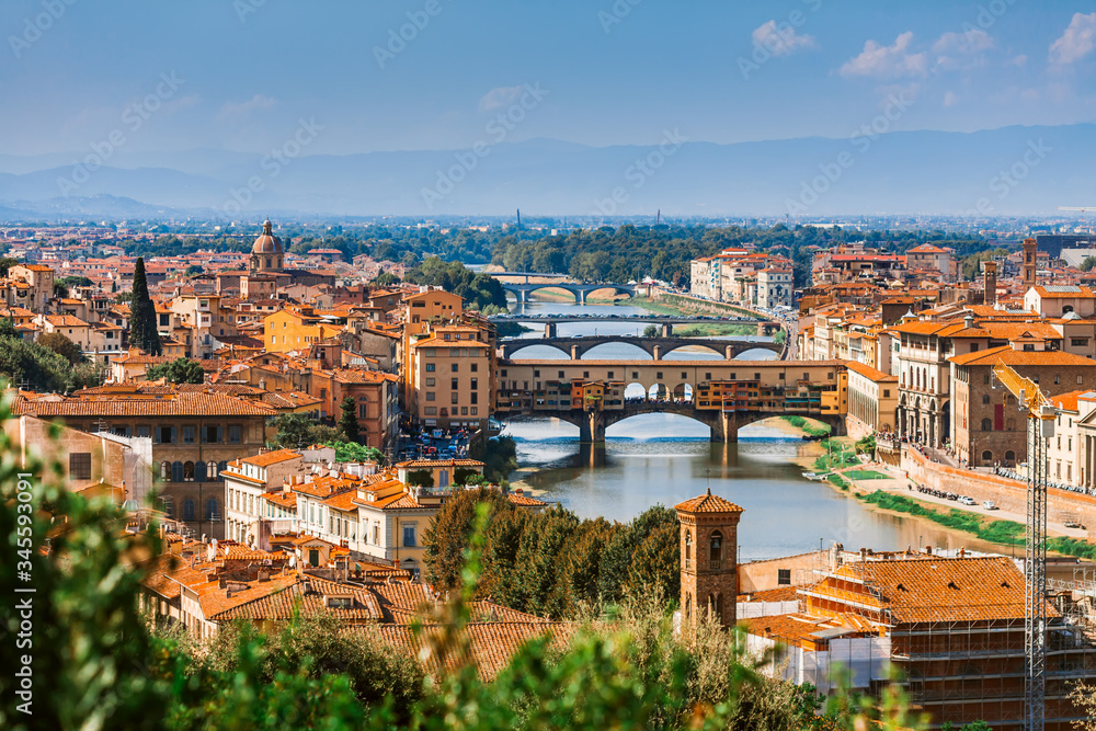 Aerial view of the Arno river and its bridges. Beautiful city landscape of Florence.