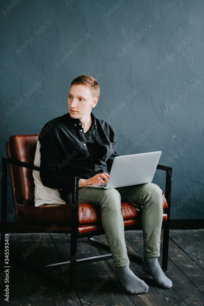Handsome young man using laptop computer at home. Handsome young man using laptop computer at home.