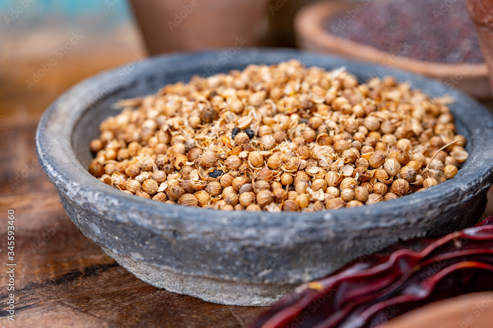 Indian spices collection, dried coriander seeds and another spices in clay bowls Indian spices collection, dried coriander seeds and another spices in clay bowls