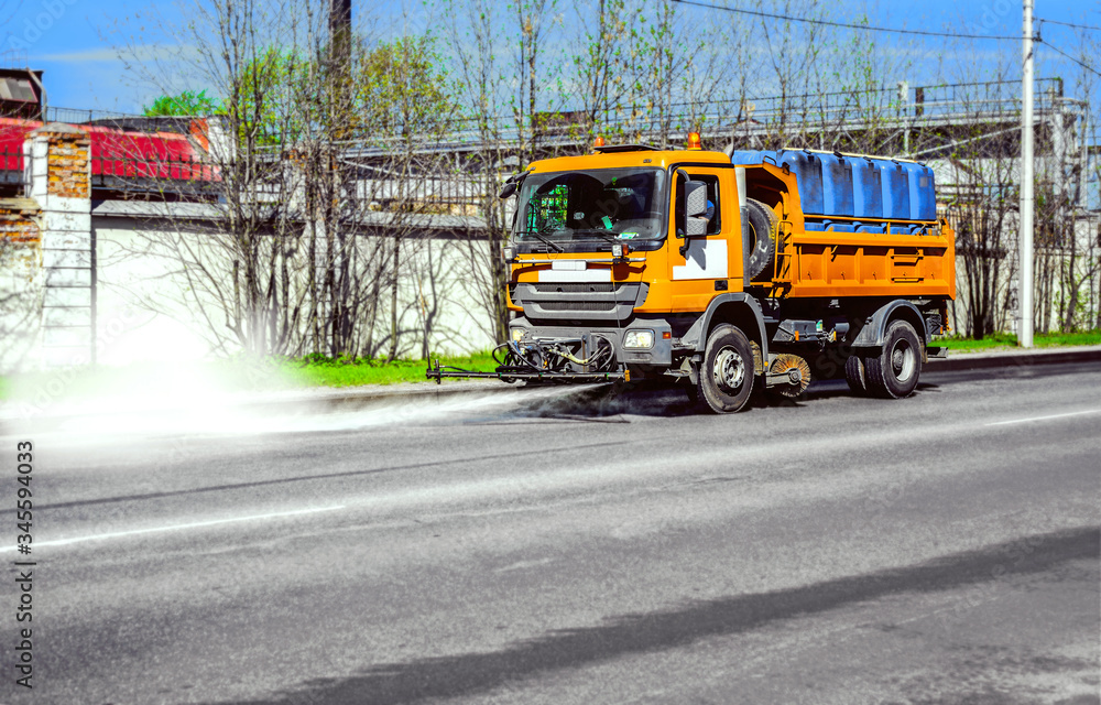 Street disinfection - a sweeper washes the city's asphalt road with water jets.