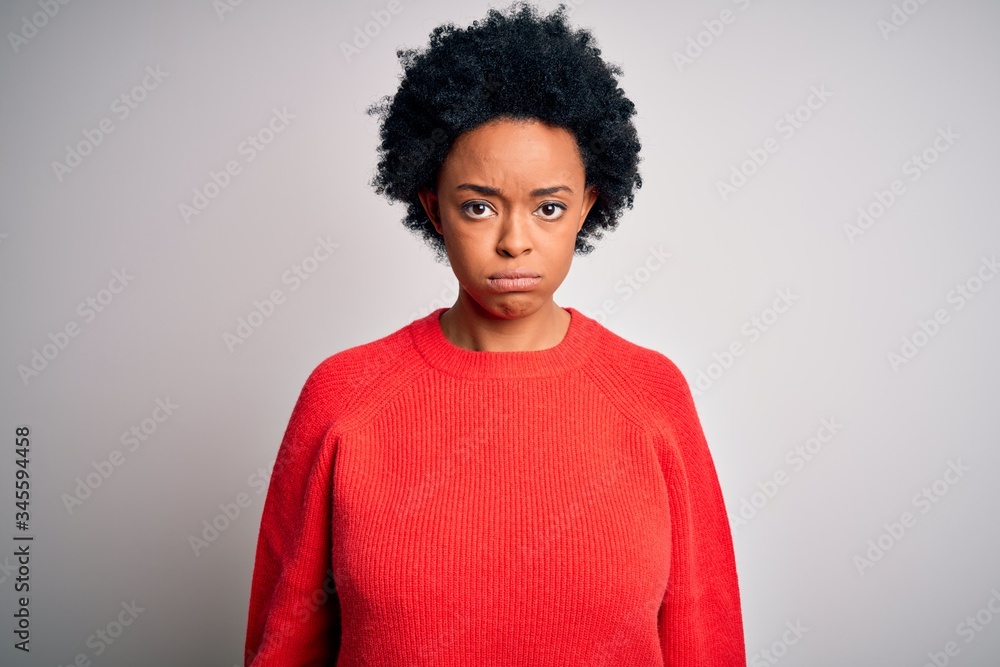 Young beautiful African American afro woman with curly hair wearing red casual sweater depressed and worry for distress, crying angry and afraid. Sad expression. Young beautiful African American afro woman with curly hair wearing red casual sweater depressed and worry for distress, crying angry and afraid. Sad expression.